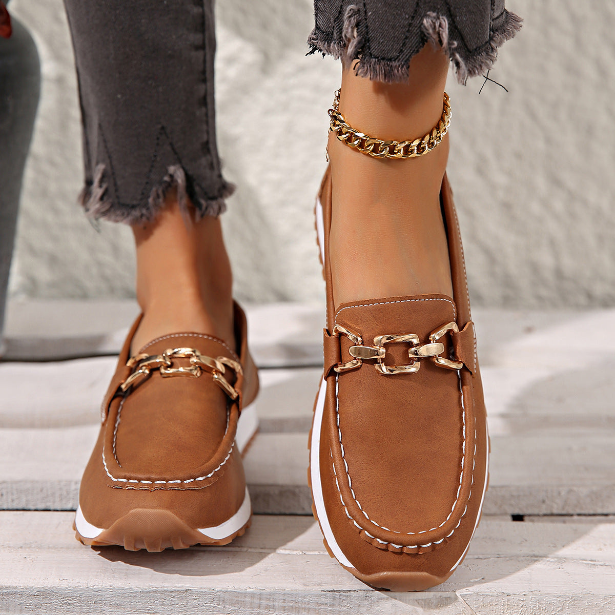 Women's flat loafers with metallic buckle trim and textured lug soles