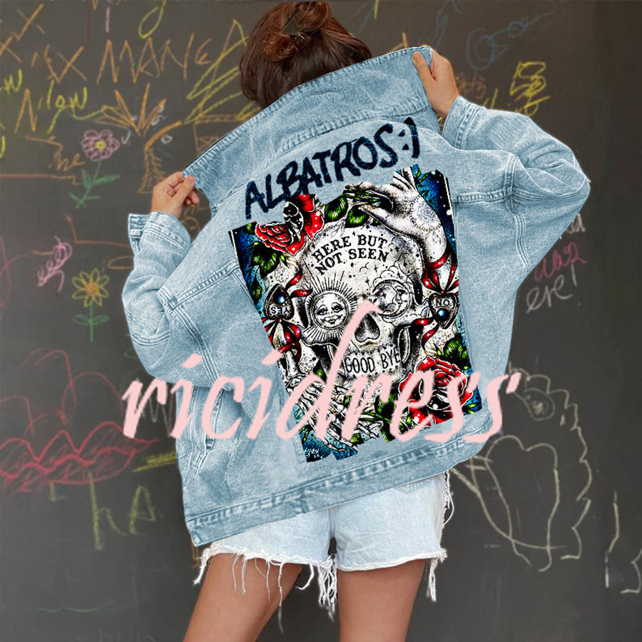 Women's light blue denim jacket with a large skull and rose graphic on the back