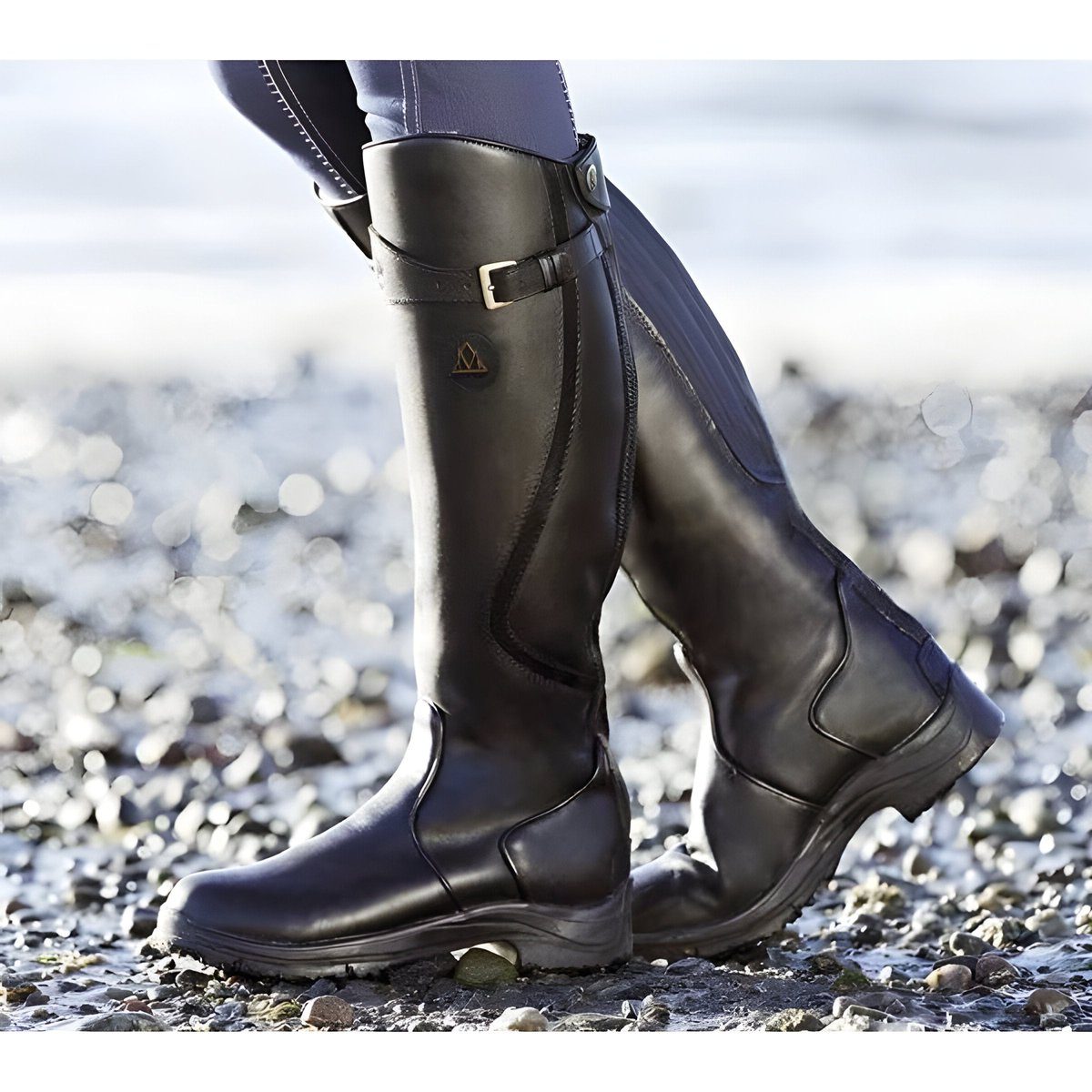 Women's knee-high riding boots with buckle strap and flat sole