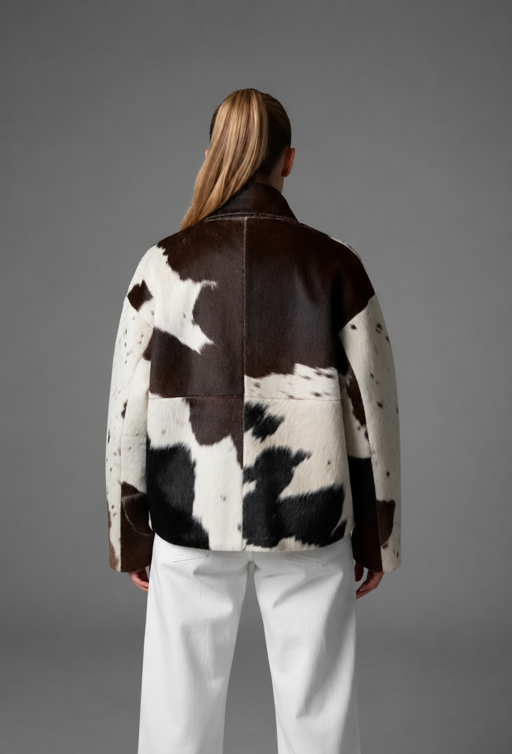 Women's brown, black and cream cow print faux fur jacket with stand collar