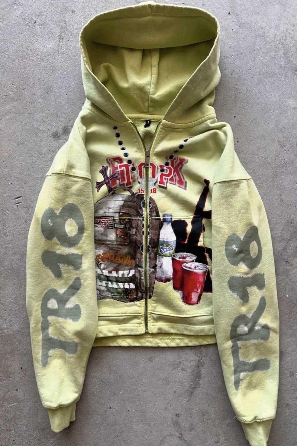 Yellow hooded zip hoodie with graphic front and sleeve prints