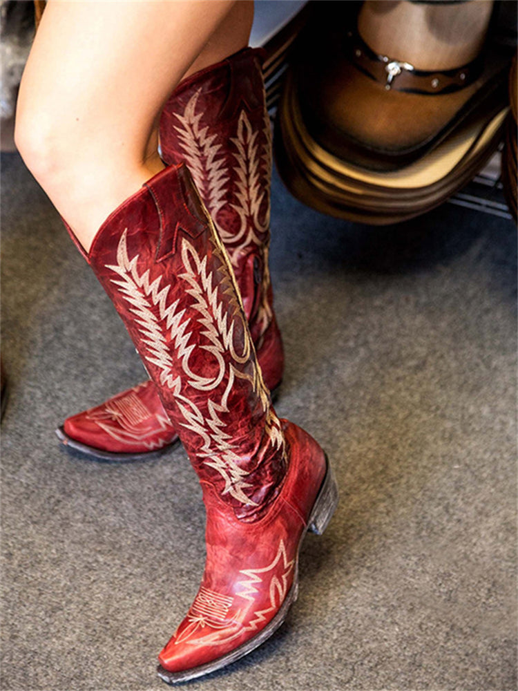 Knee-high western cowboy boots with embroidered botanical detailing and pointed toes