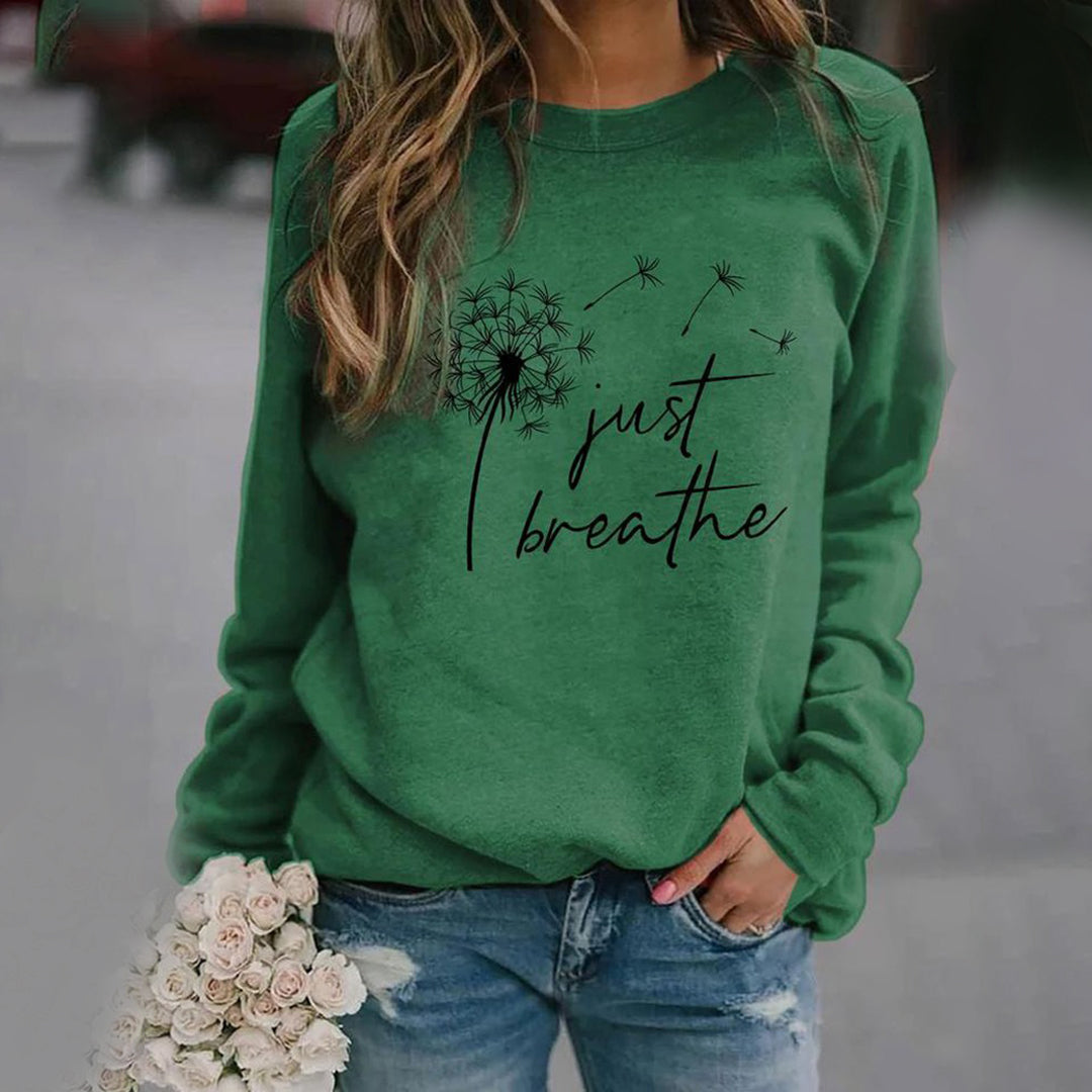 Women's long sleeve crew neck sweatshirt with dandelion and Just Breathe graphic