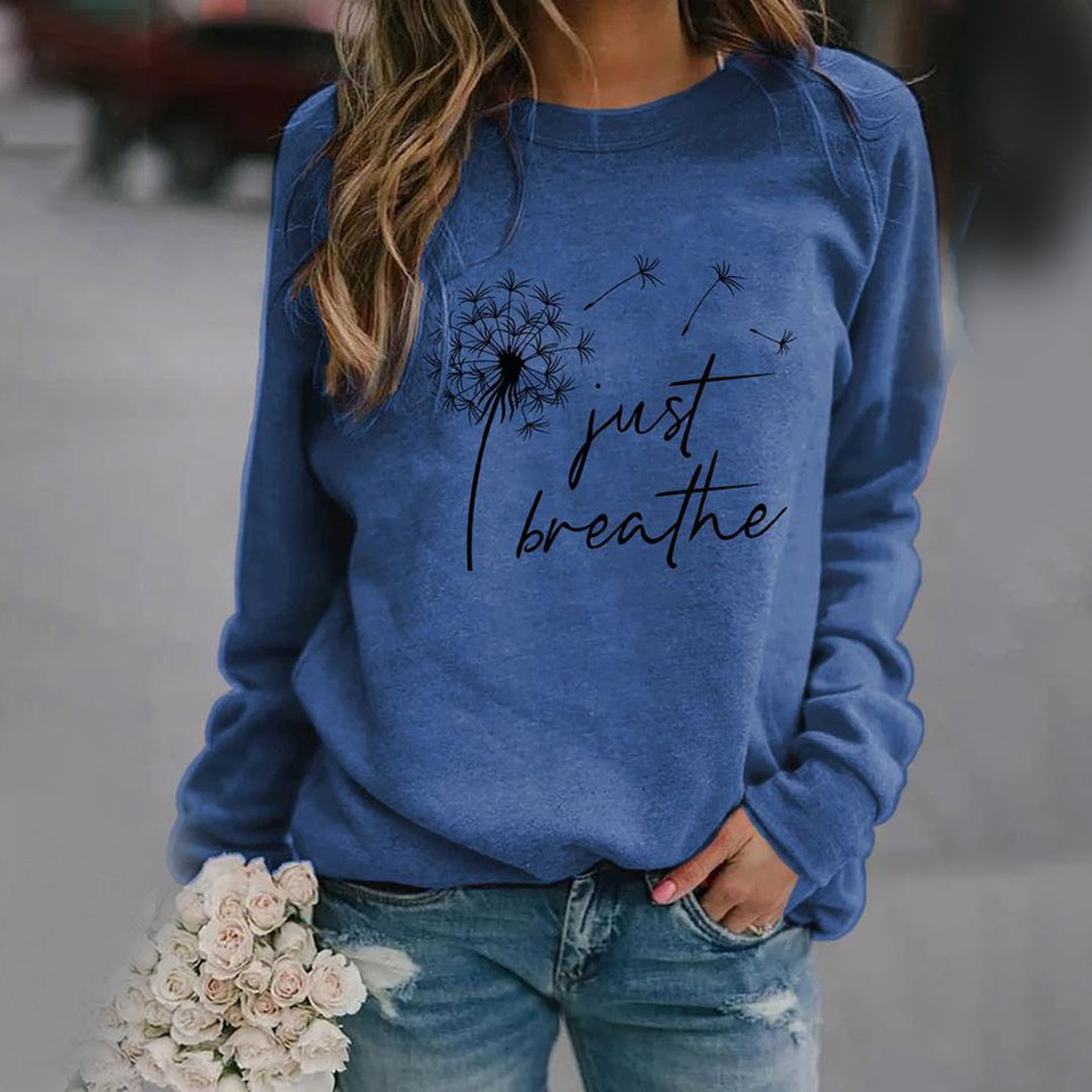 Women's long sleeve crew neck sweatshirt with dandelion and Just Breathe graphic