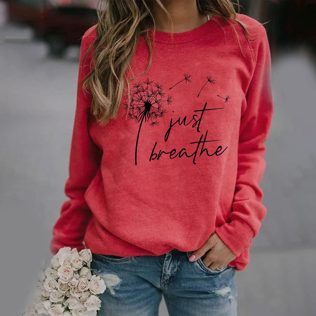 Women's long sleeve crew neck sweatshirt with dandelion and Just Breathe graphic