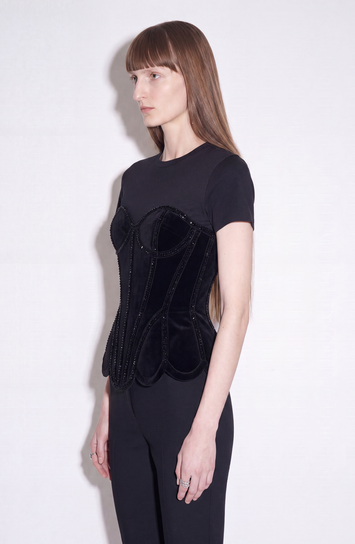 Black short-sleeve T-shirt with structured corset-style front and sparkling trim