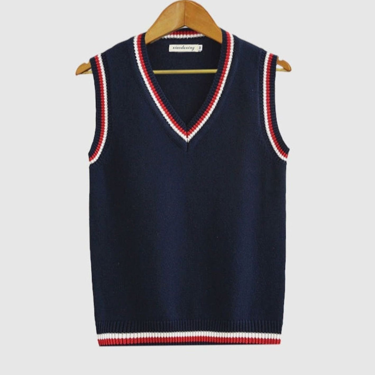 Women's sleeveless cable-knit sweater vest with striped V-neck and hem