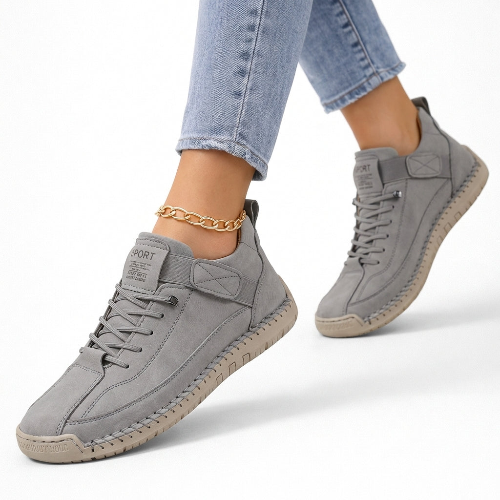 Women's lace-up ankle sneakers with rounded toes, strap detail and flat textured soles