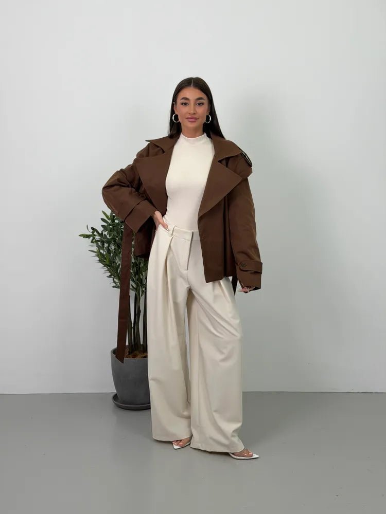 Women's brown cropped trench coat with lapels, tie belt and long sleeves