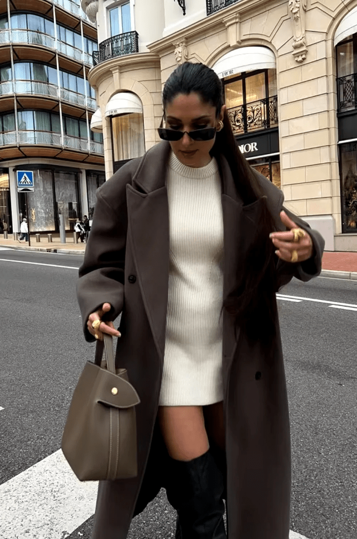 Women's long brown double-breasted coat with notched lapels and long sleeves