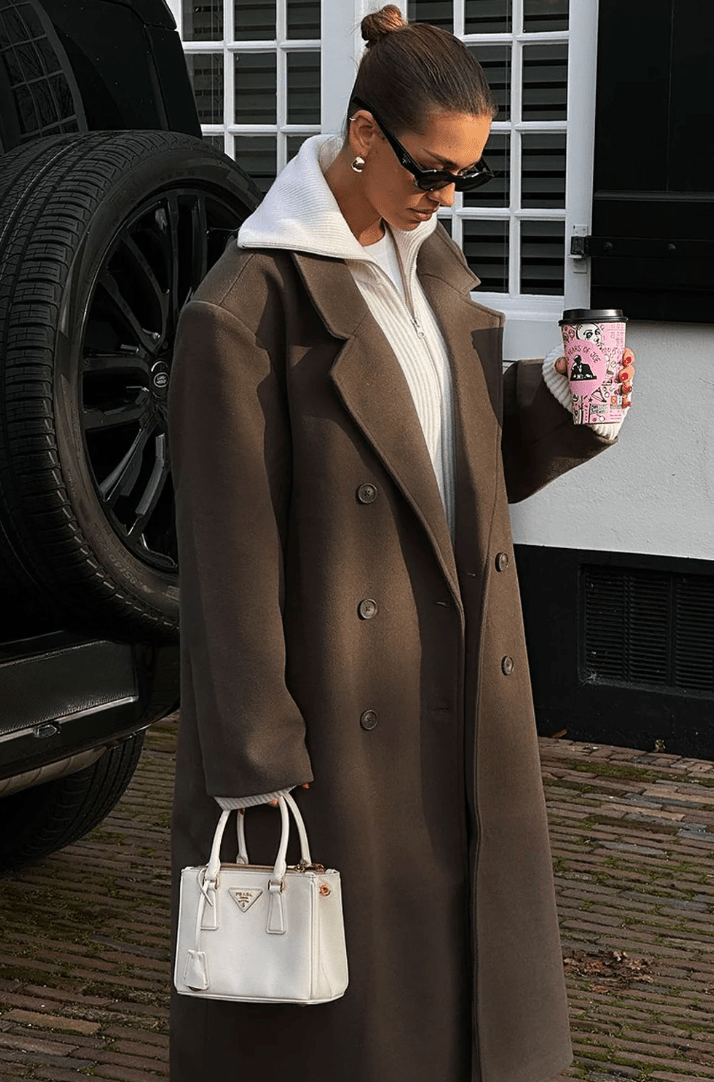 Women's long brown double-breasted coat with notched lapels and long sleeves