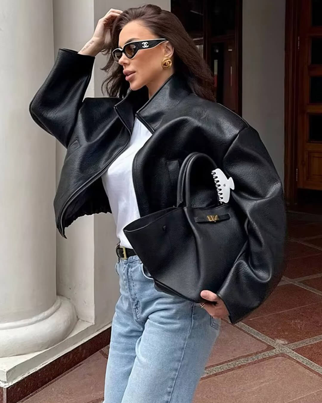 Women's black zip-up jacket with high collar and long sleeves