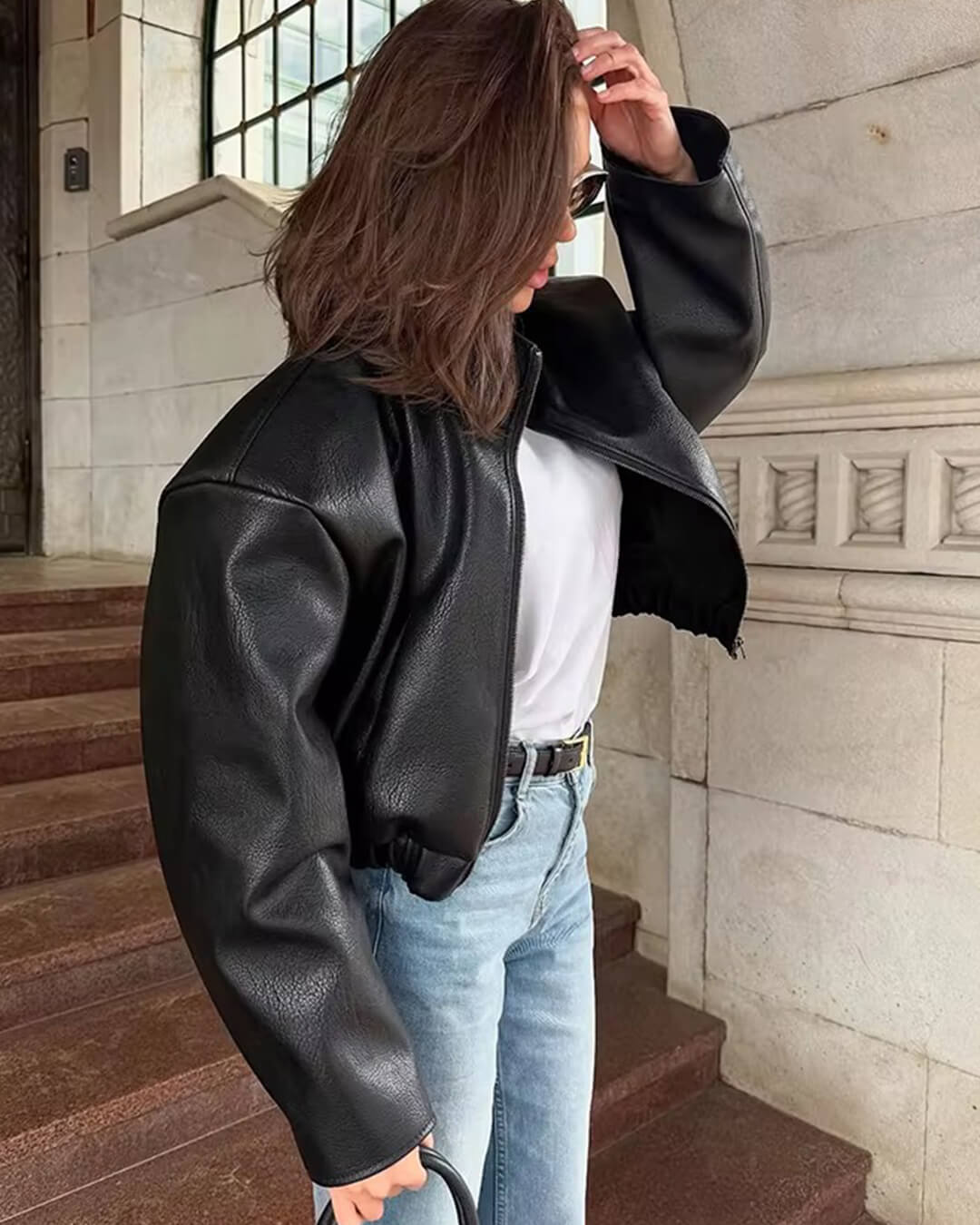 Women's black zip-up jacket with high collar and long sleeves