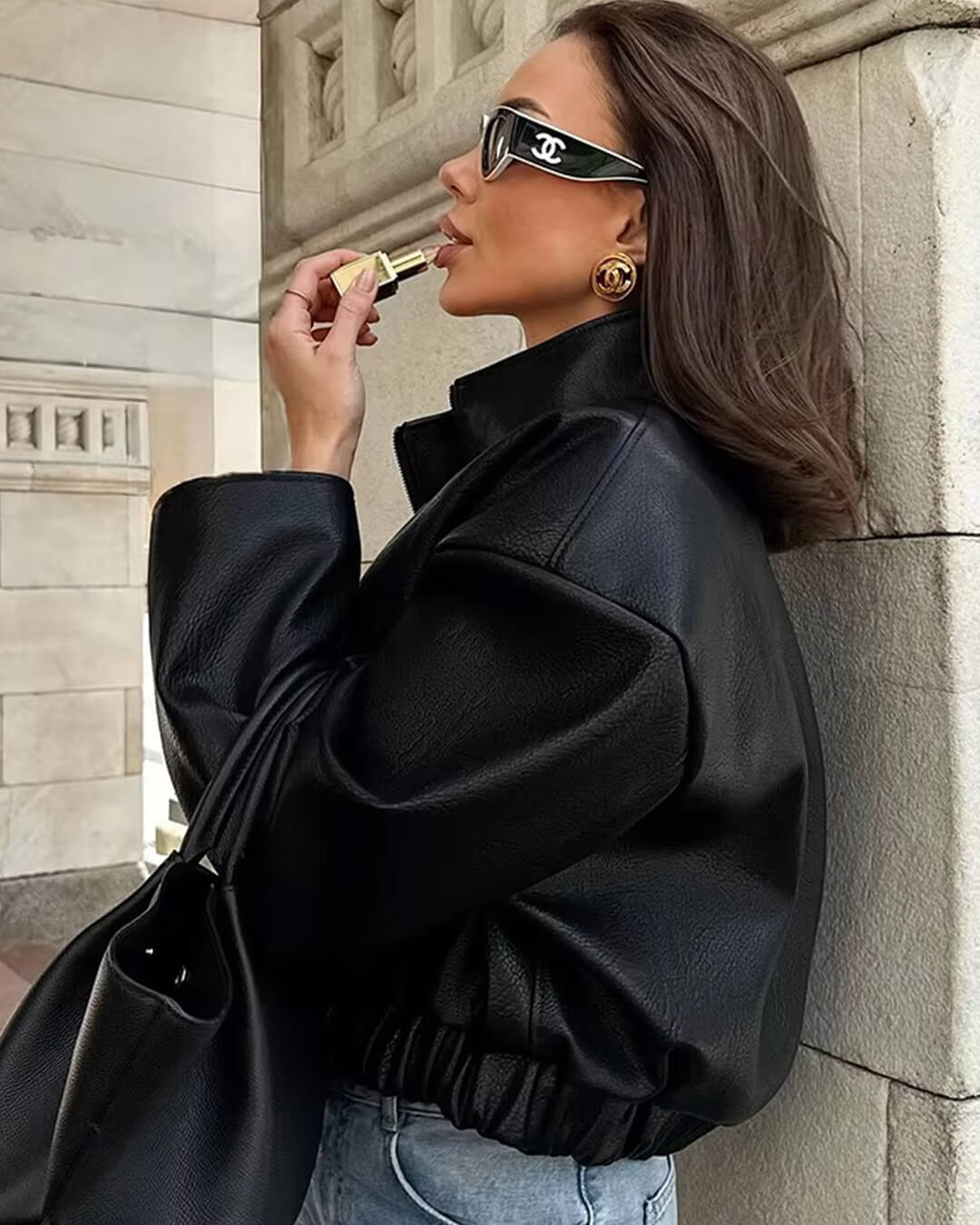 Women's black zip-up jacket with high collar and long sleeves