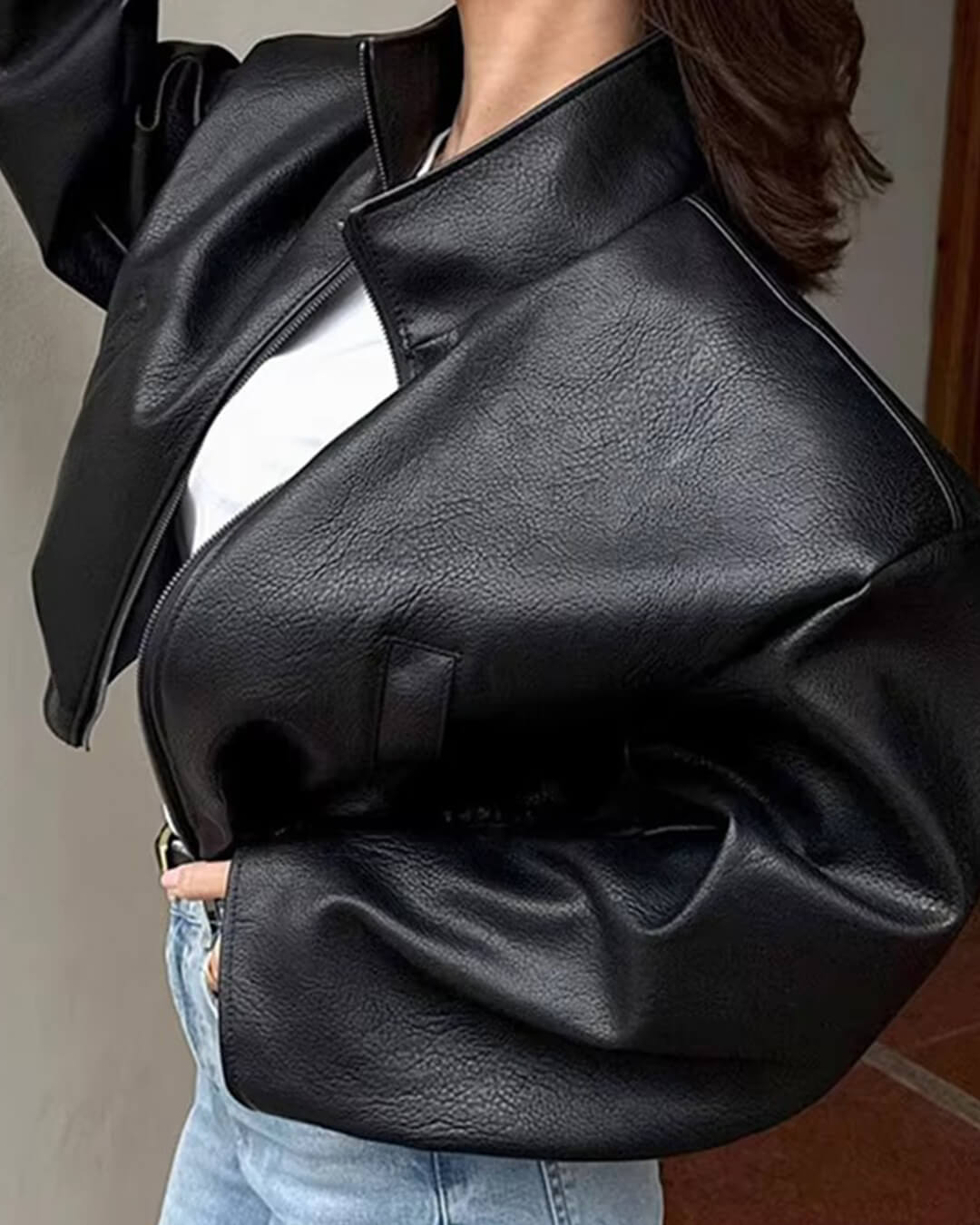 Women's black zip-up jacket with high collar and long sleeves