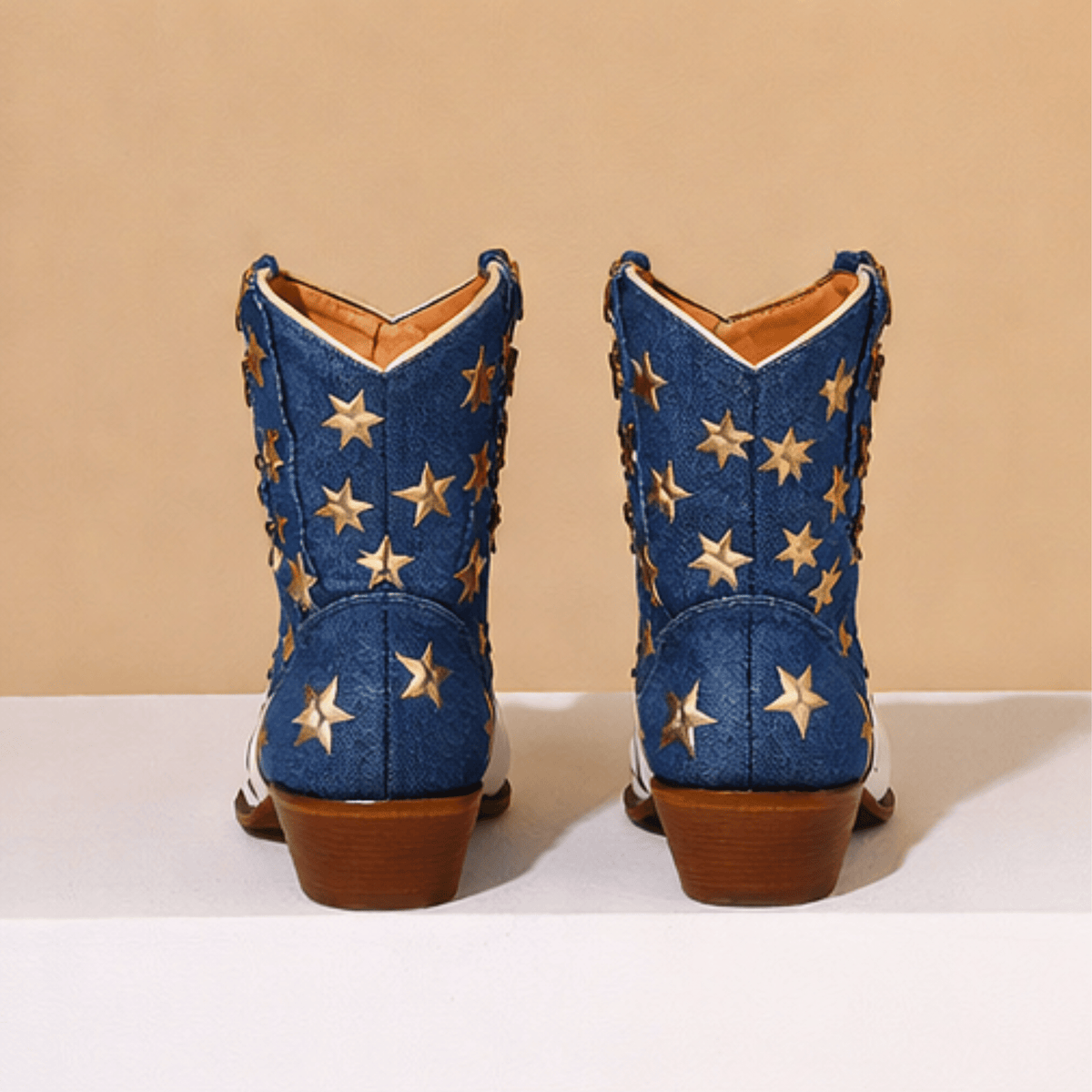 Women's ivory-white cowboy boots with red stripes, blue star panels and pointed toes
