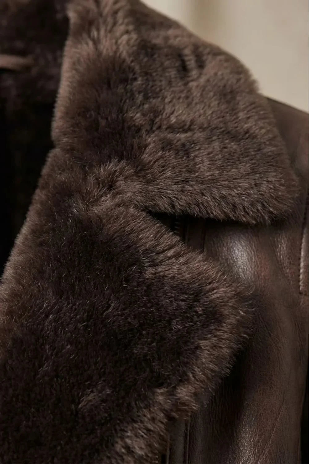 Women's brown jacket with a wide fur-trimmed collar and front zip fastening