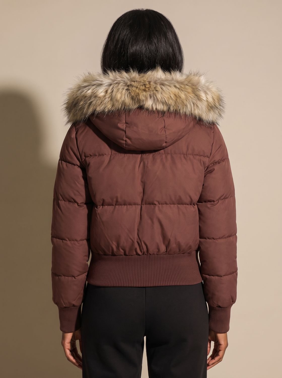 Women's hooded quilted puffer jacket with long sleeves and textured hood trim