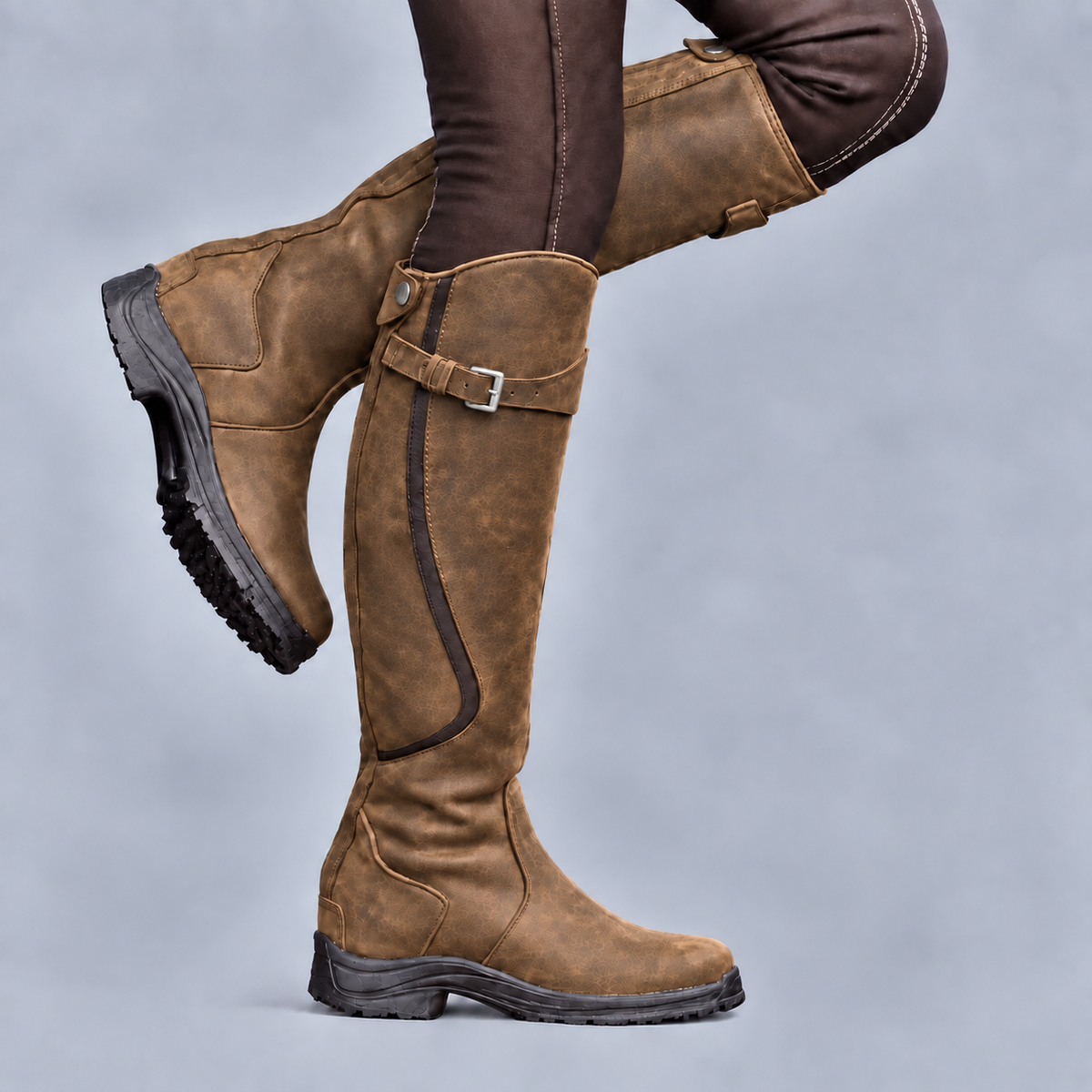 Women's tall riding boots with buckle straps and rugged tread soles