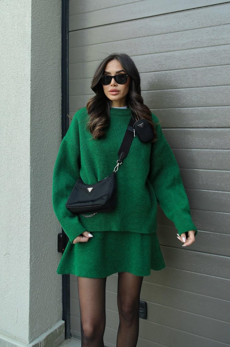 Woman wearing a plain knitted jumper and mini skirt set