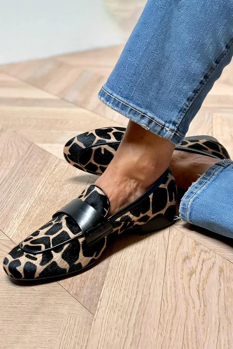 Women's black and tan animal print slip-on loafers with round toes and flat soles