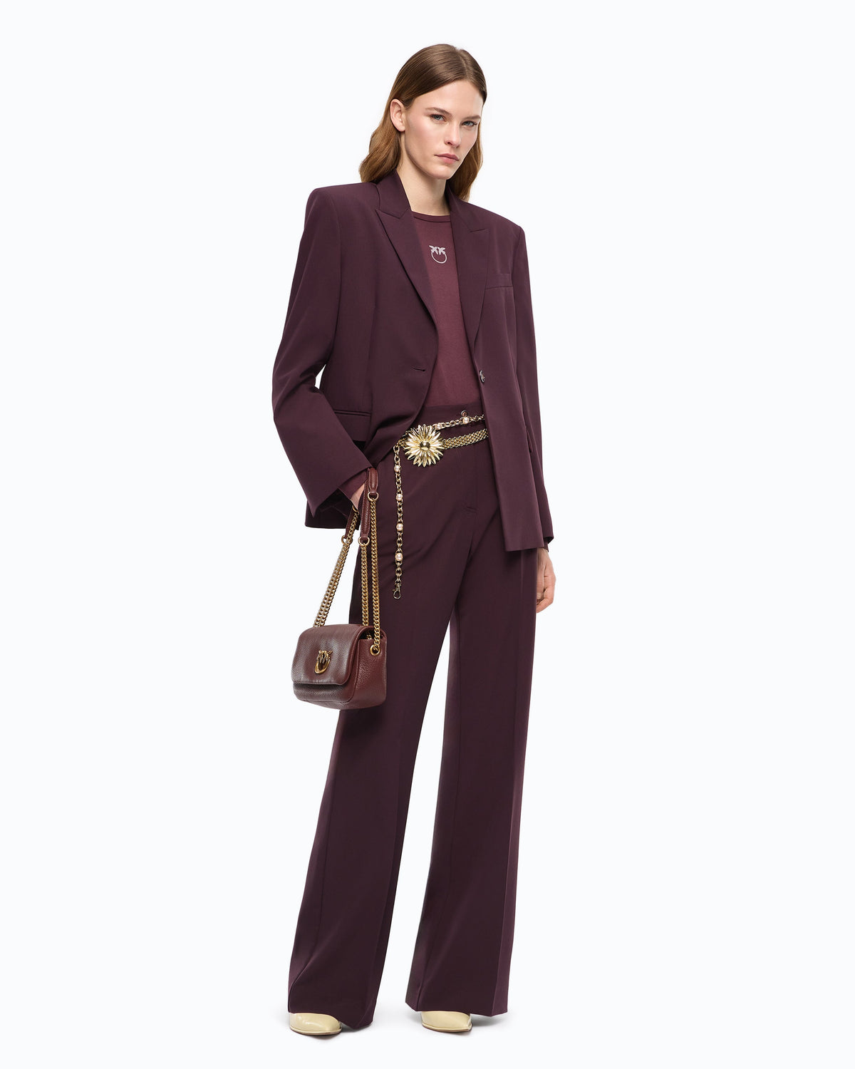 Women's burgundy tailored blazer with notched lapels and flap pockets