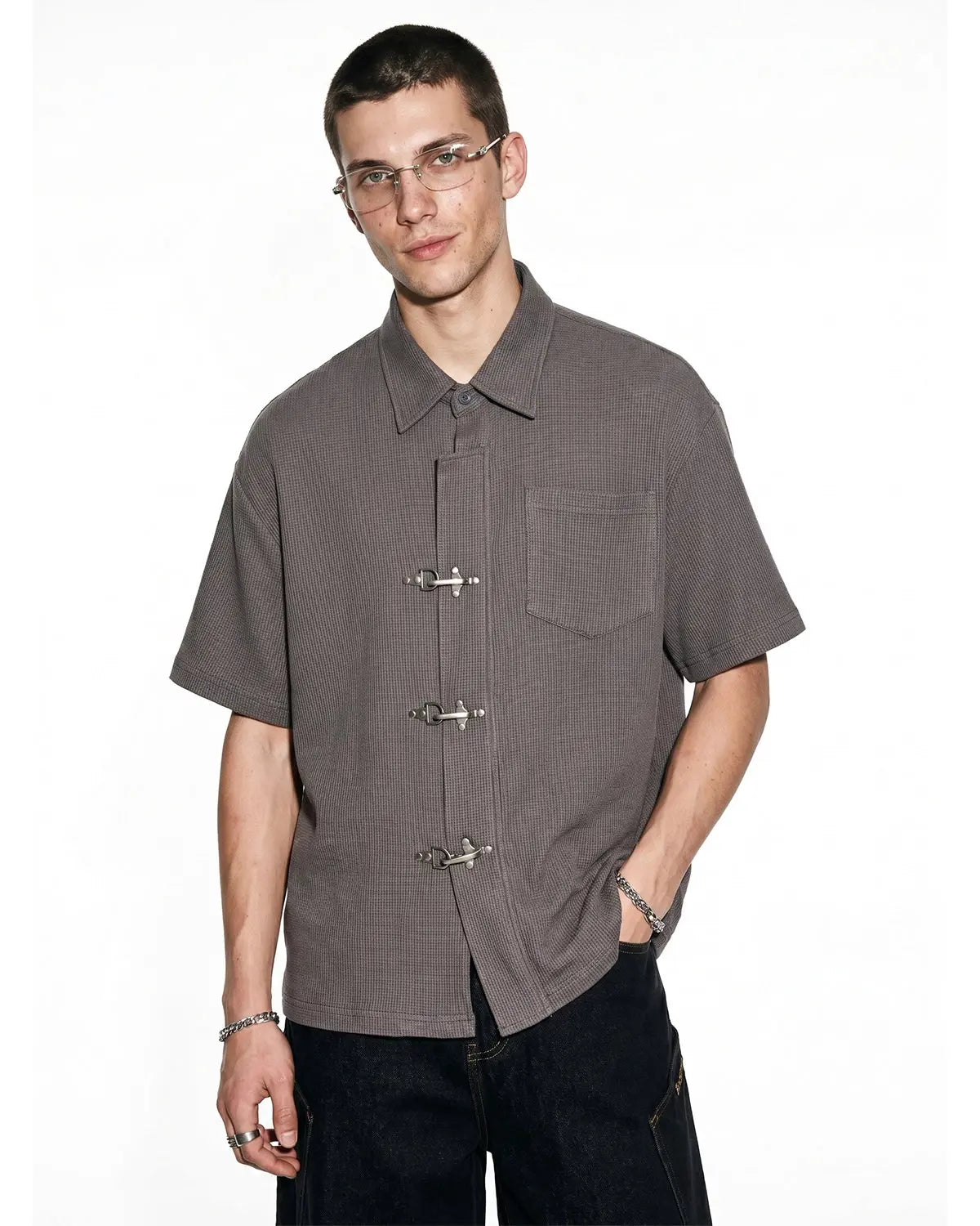 Men's grey waffle-textured short-sleeve shirt with metal clasps and chest pocket