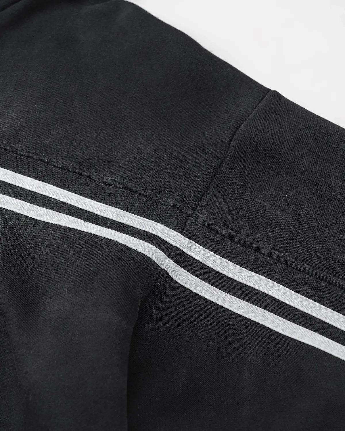 Black hooded zip-up hoodie with white double stripes and front pockets