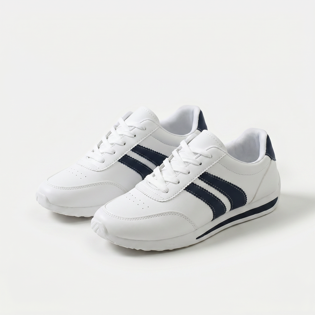 Women's white lace-up sneakers with navy side stripes and flat soles