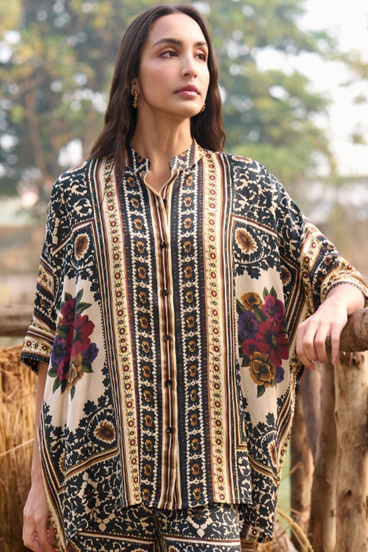 Woman wearing a multicoloured floral printed shirt and straight-cut trousers set