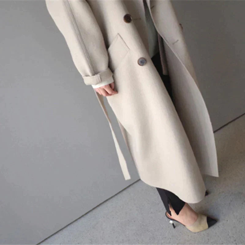 Women's long plain tailored coat with lapel collar and button front