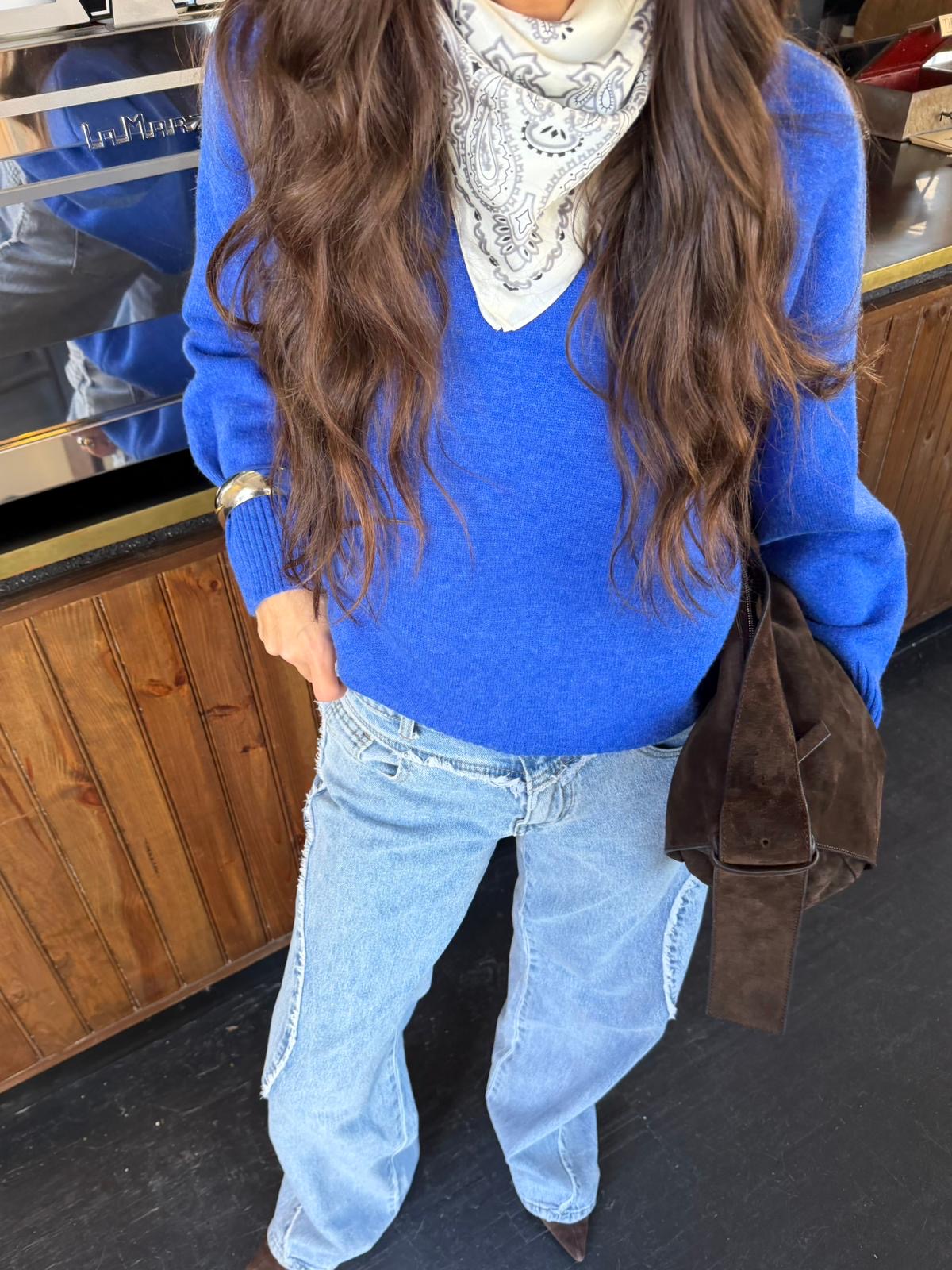 Women's blue V-neck knit sweater with long sleeves and ribbed trims