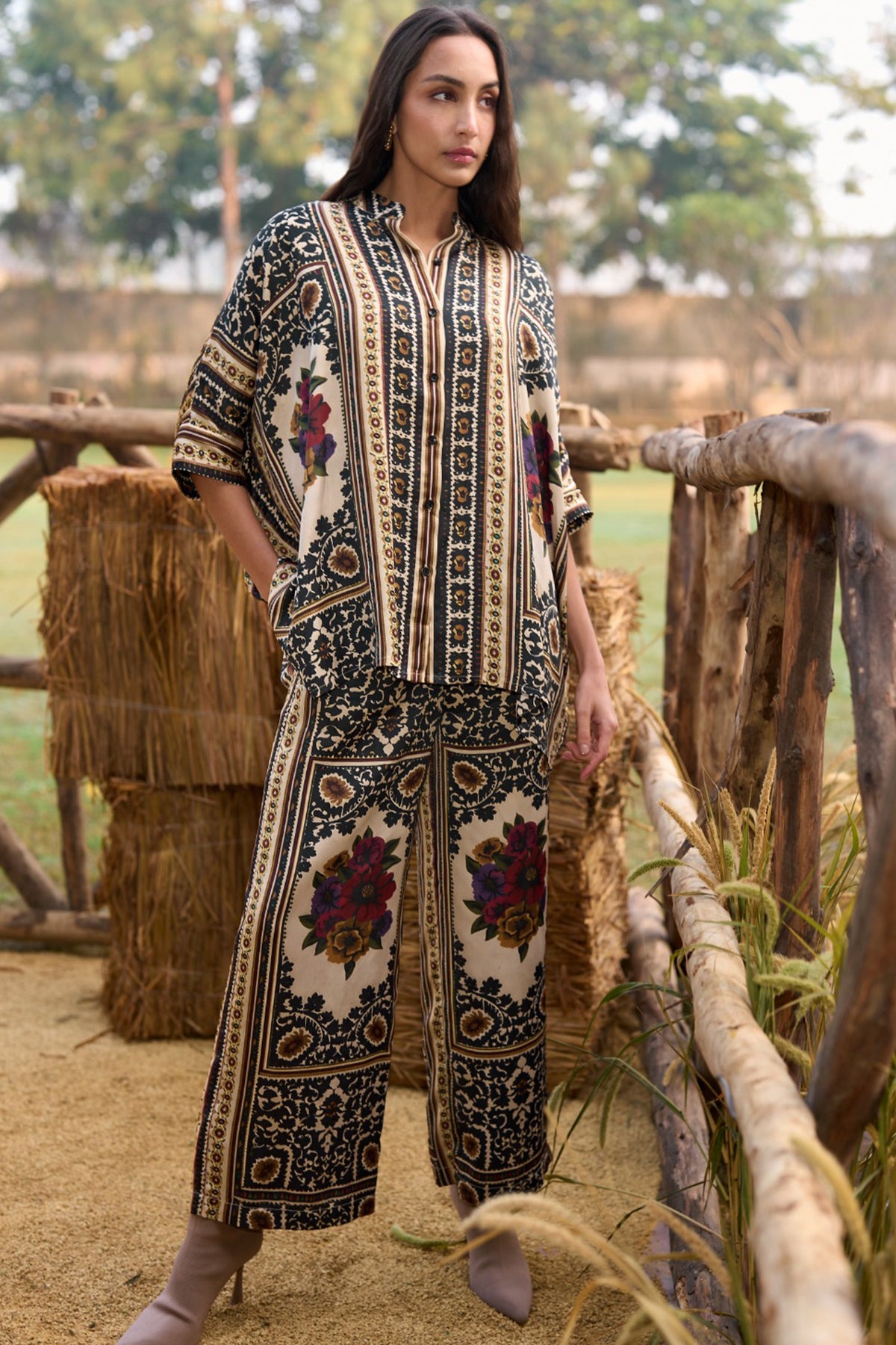 Woman wearing a multicoloured floral printed shirt and straight-cut trousers set