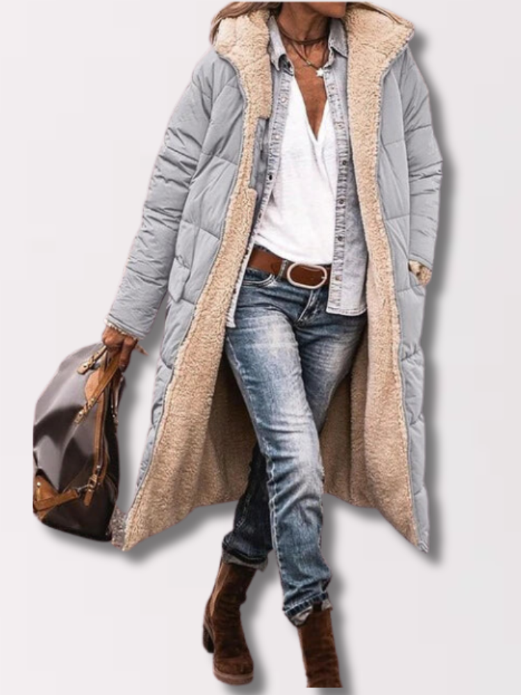 Woman wearing a long hooded quilted puffer coat with contrasting textured trim