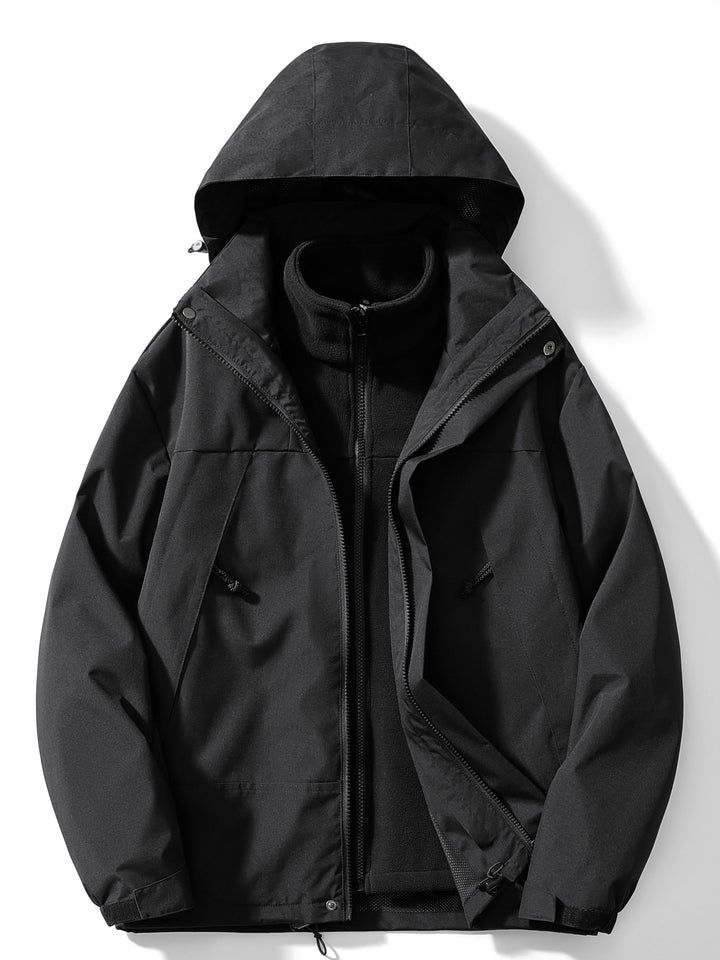 Women's hooded layered outdoor jacket with long sleeves and zipped pockets