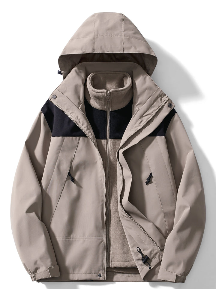 Women's hooded layered outdoor jacket with long sleeves and zipped pockets