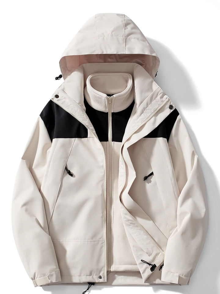 Women's hooded layered outdoor jacket with long sleeves and zipped pockets