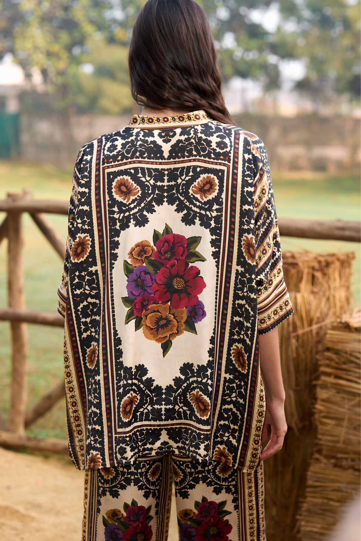 Woman wearing a multicoloured floral printed shirt and straight-cut trousers set