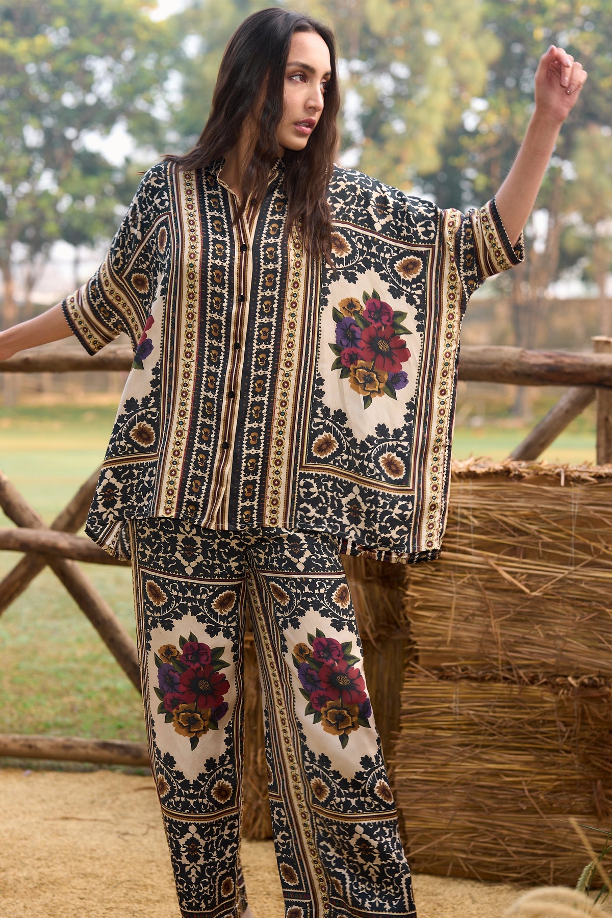 Woman wearing a multicoloured floral printed shirt and straight-cut trousers set