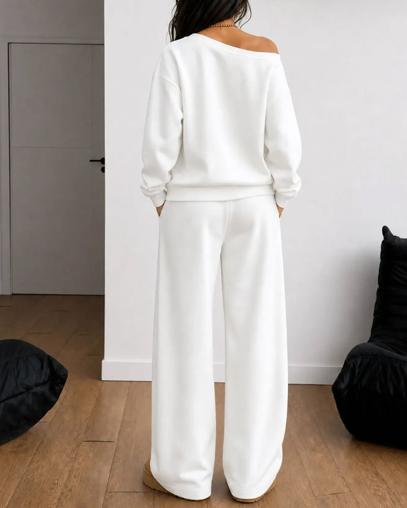 Women's asymmetric sweatshirt and wide-leg trousers set shown in white and black