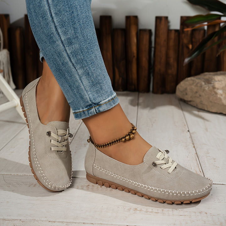 Women's moccasin loafers with lace detail, stitched trim and flat textured soles