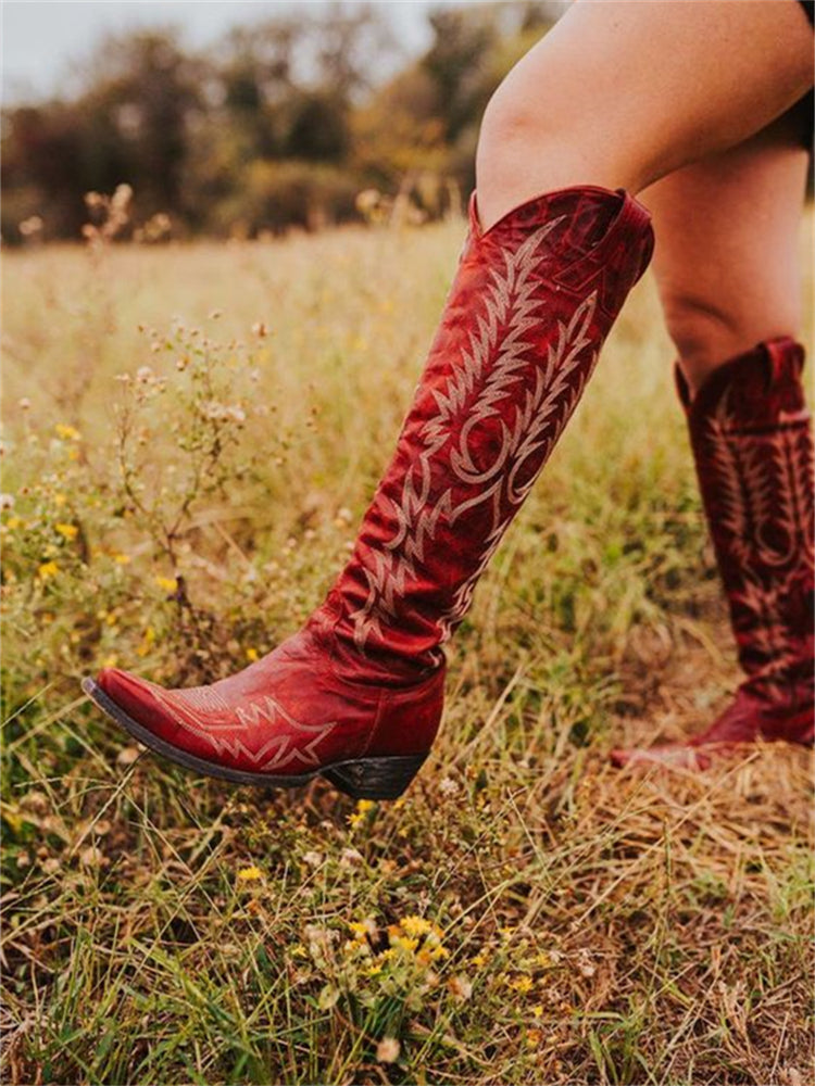 Knee-high western cowboy boots with embroidered botanical detailing and pointed toes