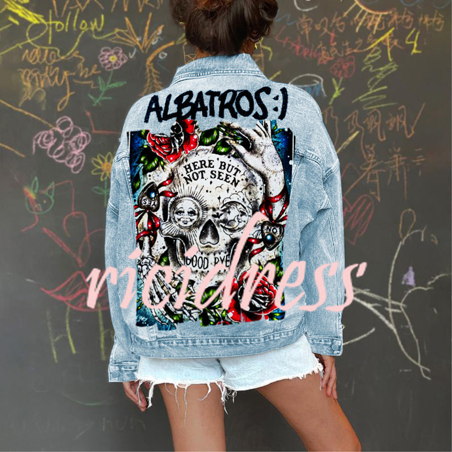 Women's light blue denim jacket with a large skull and rose graphic on the back
