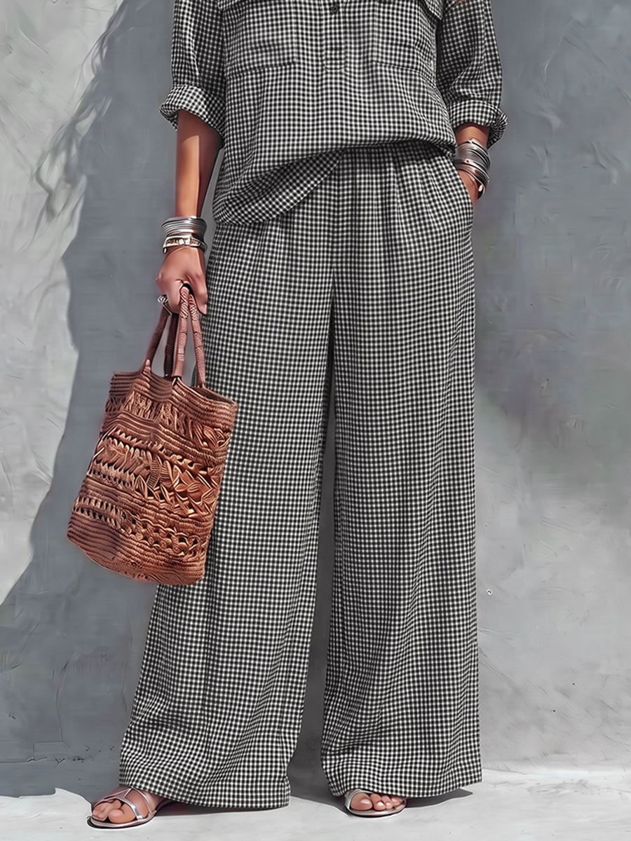 Women's black and white checked wide-leg trousers with elasticated waist and side pockets