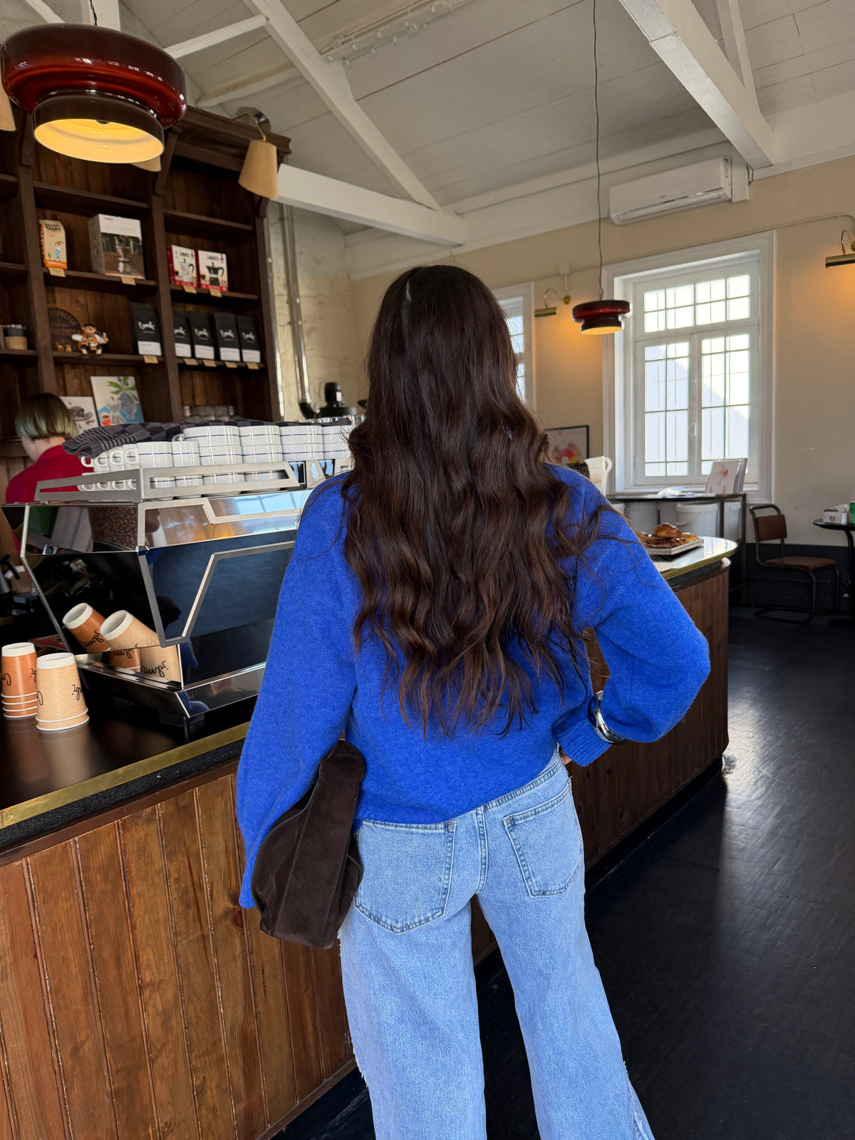 Women's blue V-neck knit sweater with long sleeves and ribbed trims