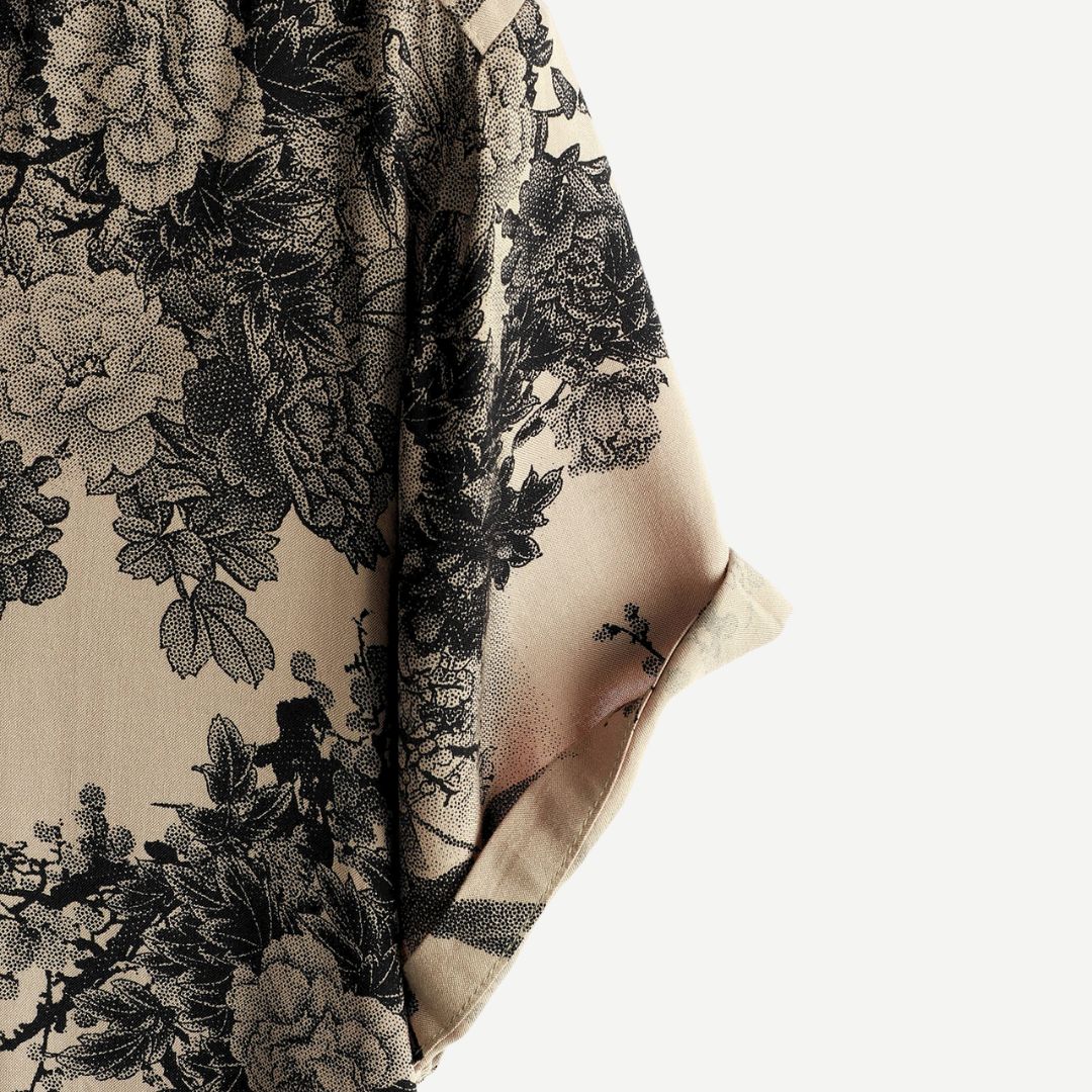 Men's beige short sleeve shirt with black floral print and button front