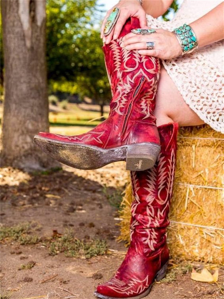 Knee-high western cowboy boots with embroidered botanical detailing and pointed toes
