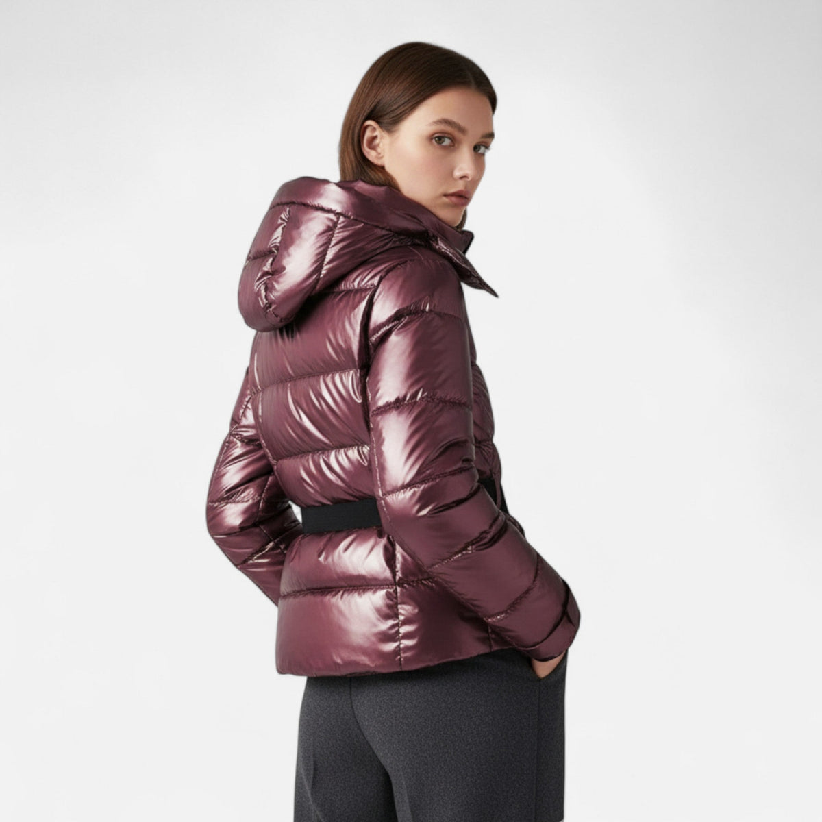 Women's hooded padded ski jacket with cinched waist, long sleeves and zipped pockets