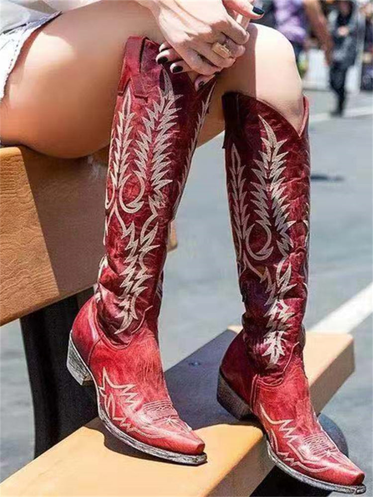 Knee-high western cowboy boots with embroidered botanical detailing and pointed toes