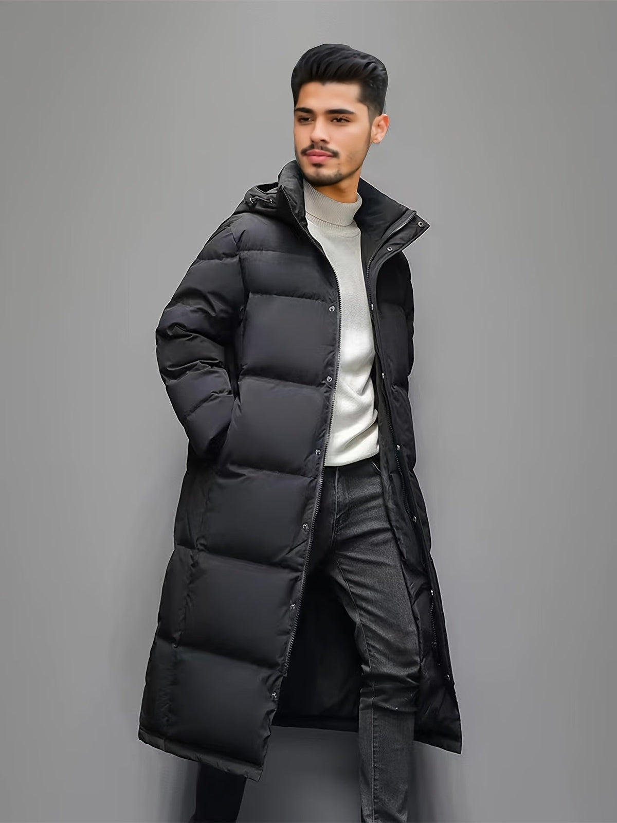 Men's black long hooded puffer coat with quilted panels and front zip